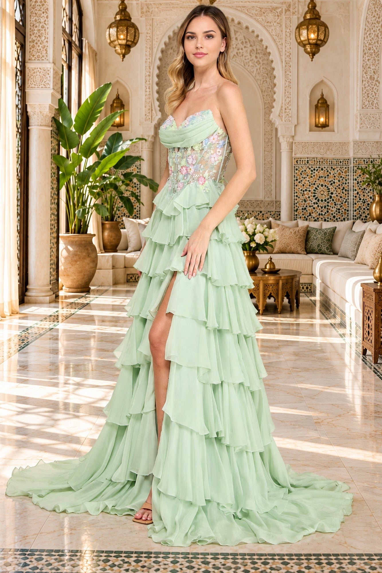 Amelia Couture 9103, a woman in a light green ruffled chiffon prom dress with a strapless sweetheart neckline, floral embroidery on the bodice, and a high slit.